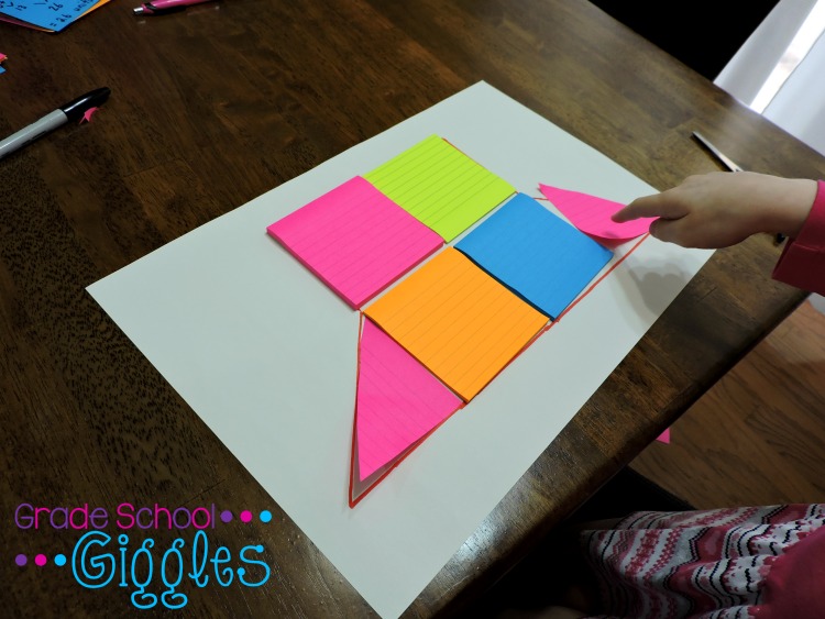 Square sticky notes are used to tile a figure.