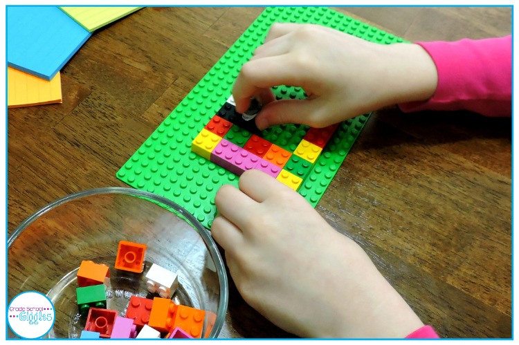 A child is building a figure out of building bricks.